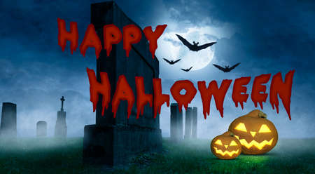 a happy halloween greeting card with pumpkins on a cemeteryの写真素材
