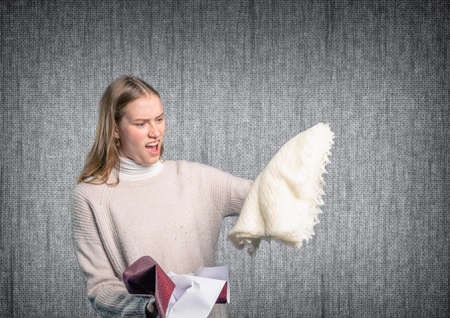 a woman is disappointed and angry about her giftの写真素材