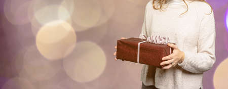 closeup of a woman is holding a gift with text-free spaceの写真素材