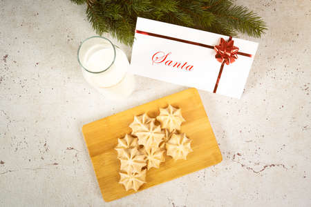 Milk and biscuits for santa with an envelope on a table view from the topの写真素材