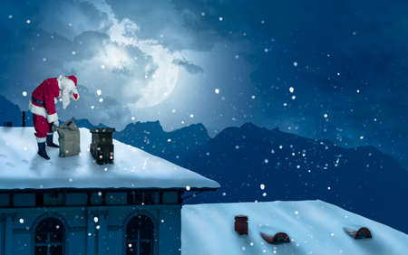 Santa on a snow-covered roof with gifts sack is exhaused from workの写真素材