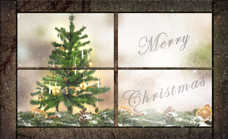 merry christmas text written on a window with decorated Christmas tree behind itの写真素材