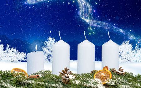 one candle on an advent wreath burns with wintery background and snowの写真素材