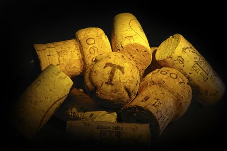          Heap of cork, on the black back ground with yellow shines.                        の写真素材