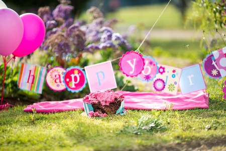 Smashed up birthday cake taken at end of party and messing the antique distressed wooden floorの写真素材