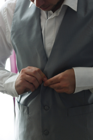 Businessman buttons gray vest. Elegant man  or groom dressing upの写真素材
