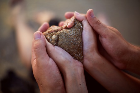 hands of young people holding wedding ringsの写真素材