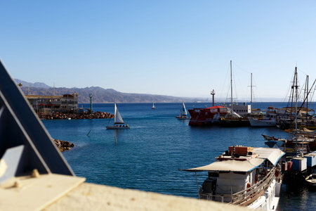 Beautiful sea landscape in Montenegro background in retro style. Boats and yachts in a bay of...