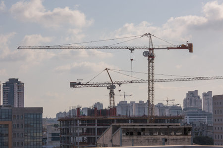 the construction crane and the building against the blue sky