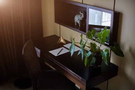 Office table with notepad, vintage envelope and supplies. View from above with copy spaceの写真素材