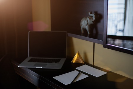 Office table with notepad, vintage envelope and supplies. View from above with copy spaceの写真素材