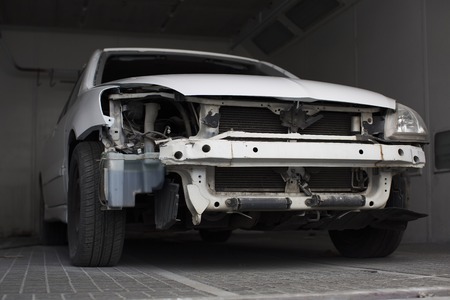 broken white car in the garageの写真素材