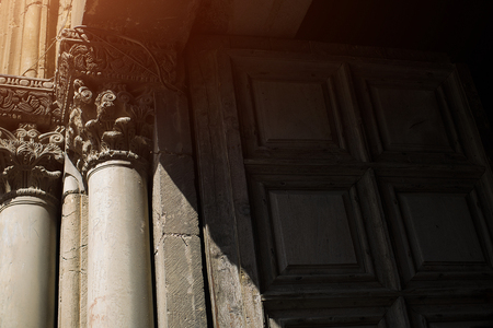 Ancient wooden door and marble pillars at the entrance to Church of the Holy Sepulchre in Jerusalem, Israel.の写真素材