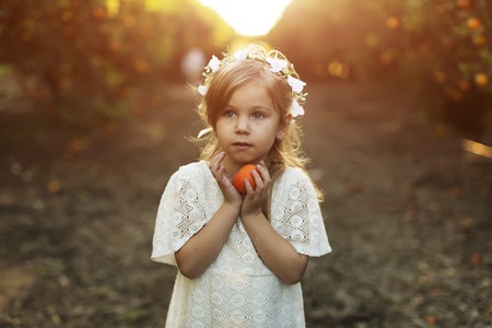 little girl with orangesの写真素材