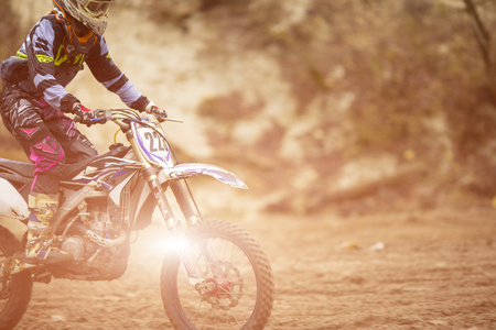 Motocross, enduro rider on dirt track. Extreme off-road race. Hard enduro motorbike. The forest behind him.の写真素材