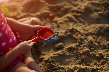 play, sand, sea, beach blue child childhood cute fun girl happy kidの写真素材
