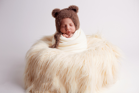 sleeping newborn baby in a basketの写真素材