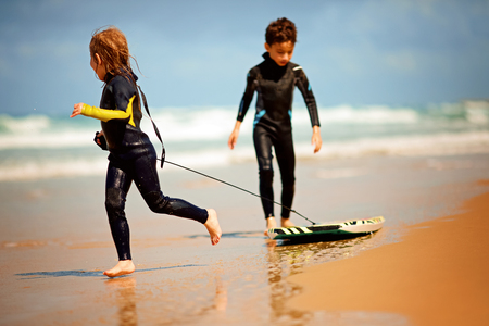 Family time. brother and sister having Fun at the Beachの写真素材