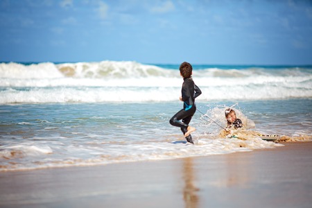 happy kids playing on beach in the day timeの写真素材