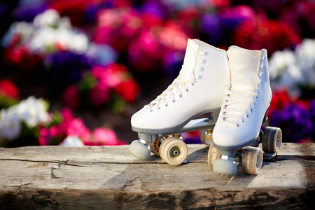 white female skates on the background of flowersの写真素材