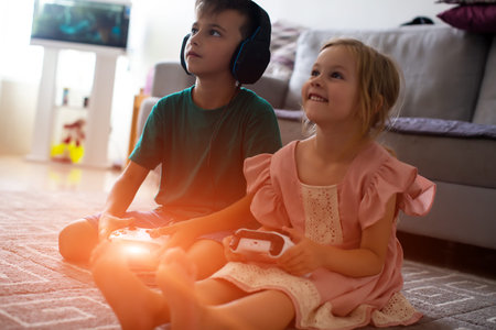 Happy children girl and boy playing a video game