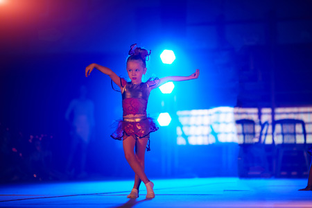 Cute little girl dreams of becoming a ballerina. Child girl in a pink tutu dancing in a room. Baby girl is studying ballet.の写真素材