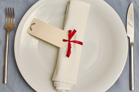 Empty white plate with nupkin on a gray backgroundの写真素材