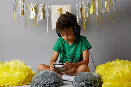 Photo of the boy with joystick playing computer game