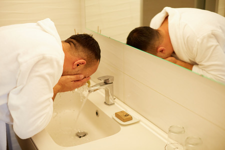 Close up of man washing hands with soap in the bathroomの写真素材