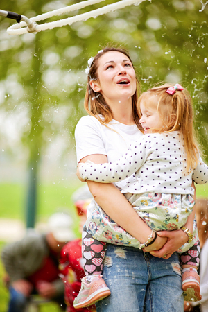 Happy mother and her daughter playing soap bubbles in park April 1, 2019, israel, Tel Avivのeditorial素材