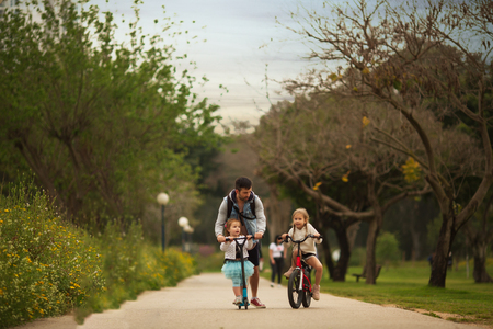 family on a morning bike ride in the Parkの写真素材