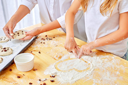 Close Up photo of young housewife putting cut dough pieces on a baking pan