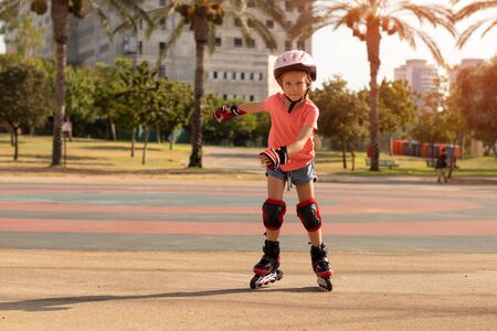 Child on inline skates in park. Kids learn to skate roller bladesの写真素材