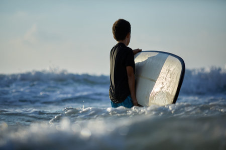 Young caucasian man surfs the ocean wave
