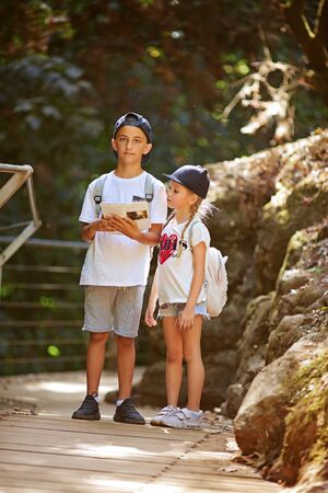 two little kids read orientation forest mapの写真素材