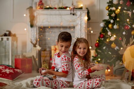 Adorable little girl and boy in Christmas timeの写真素材