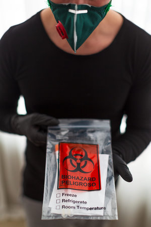 man in a protective mask holds a test