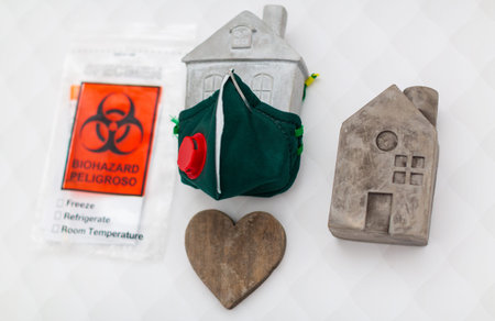 medical mask closes the model of the house on a white background. protection of housing against...
