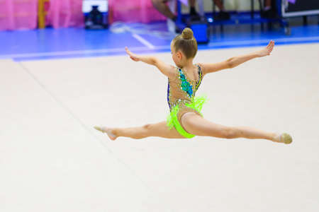 floor exercise split jump female gymnast at gymnastics championshipの写真素材