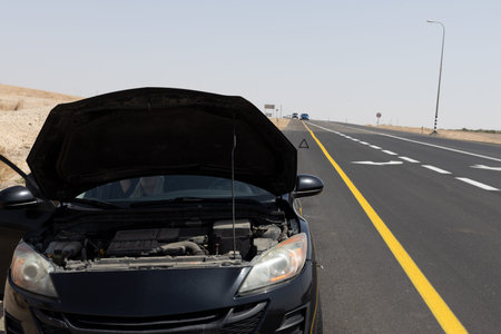 girl sitting in a broken car on the side of the road