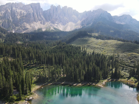 Stunning Mountain Landscape Featuring a Serene Lake Surrounded by Karersee, Carezza lake, is a lake in the Dolomites in South Tyrol, Italyの写真素材