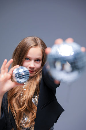 A Stylish Girl poses with Disco Balls during an Artistic Fashion Shoot full of energy and elegance