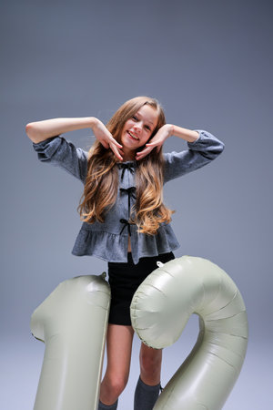 A Stylish and Cheerful Celebration of a 12th Birthday with Fun and Playful Posesの写真素材