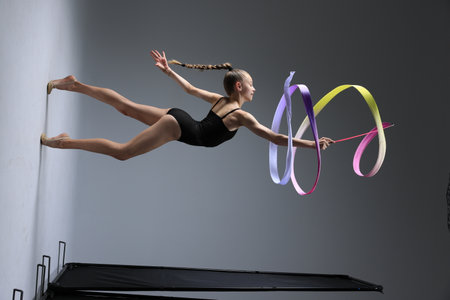 A Graceful and Stunning Gymnastics Performance Featuring Ribbons in Dynamic Motionの写真素材