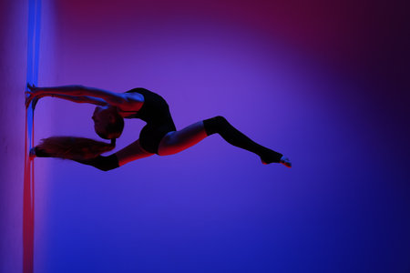 A Captivating Dynamic Dance Pose Accompanied by EyeCatching and Vibrant Lighting Effectsの写真素材