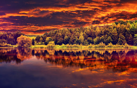 fantastic view of the dark overcast sky , reflected in the water in river Dramatic and picturesque evening scene. majestic, unusual sunset. Beauty world.の写真素材