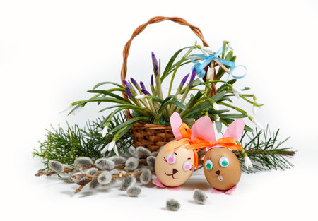 spring easter composition, decorative rabbits - eggs, on background basket with spring flowers