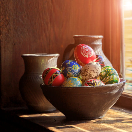 Easter eggs in a clay plate. lit by the sun from the window. wooden texture. Easter background....