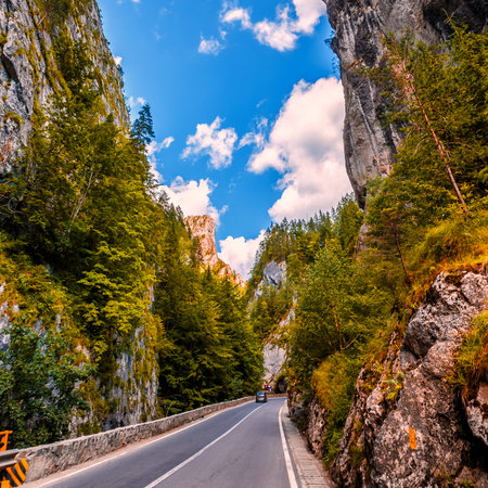 majestic mountain scenery. road in mountains, autumn forest a glowing in sunlight. Romania- Carpathian Mountains. Bicaz Canyon Cheile Bicazului . Beauty in the worldの写真素材