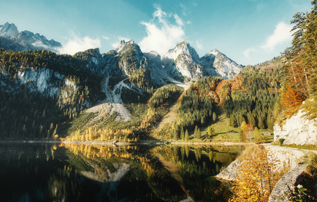 Sunny morning, at Vorderer Gosausee lake. picturesque autumn scenery. Lake under Warm sun. view of Austrian Alps, Austria, Europe. Beauty in the world. concept of travel.の写真素材